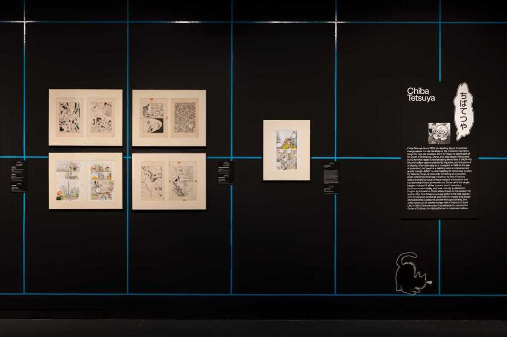 Installation view of Art of Manga at the Brooklyn Museum, with framed original manga pages displayed on a dark gallery wall