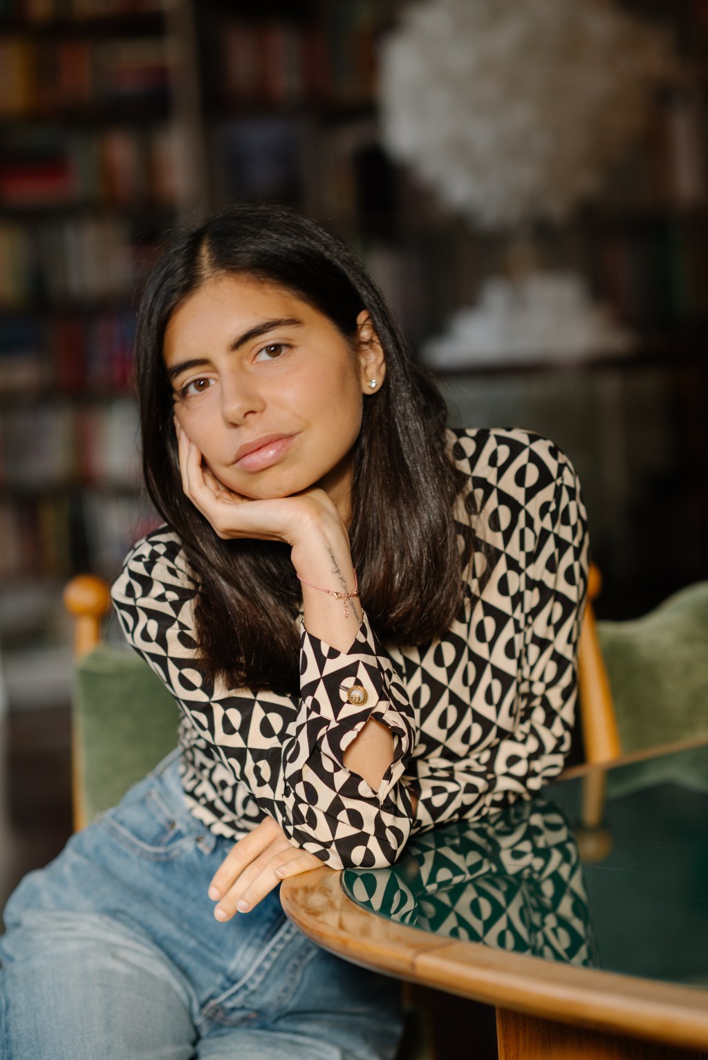 Author Doménica Feraud seated at a table