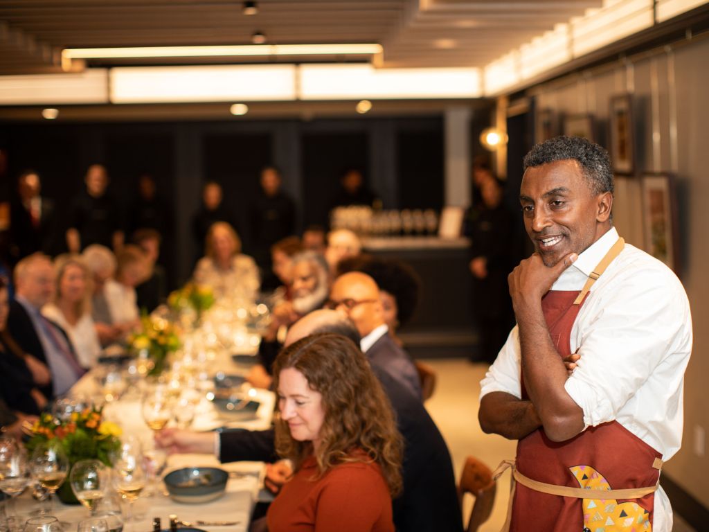 A chef addresses guests at a dinner at Platform by the James Beard Foundation