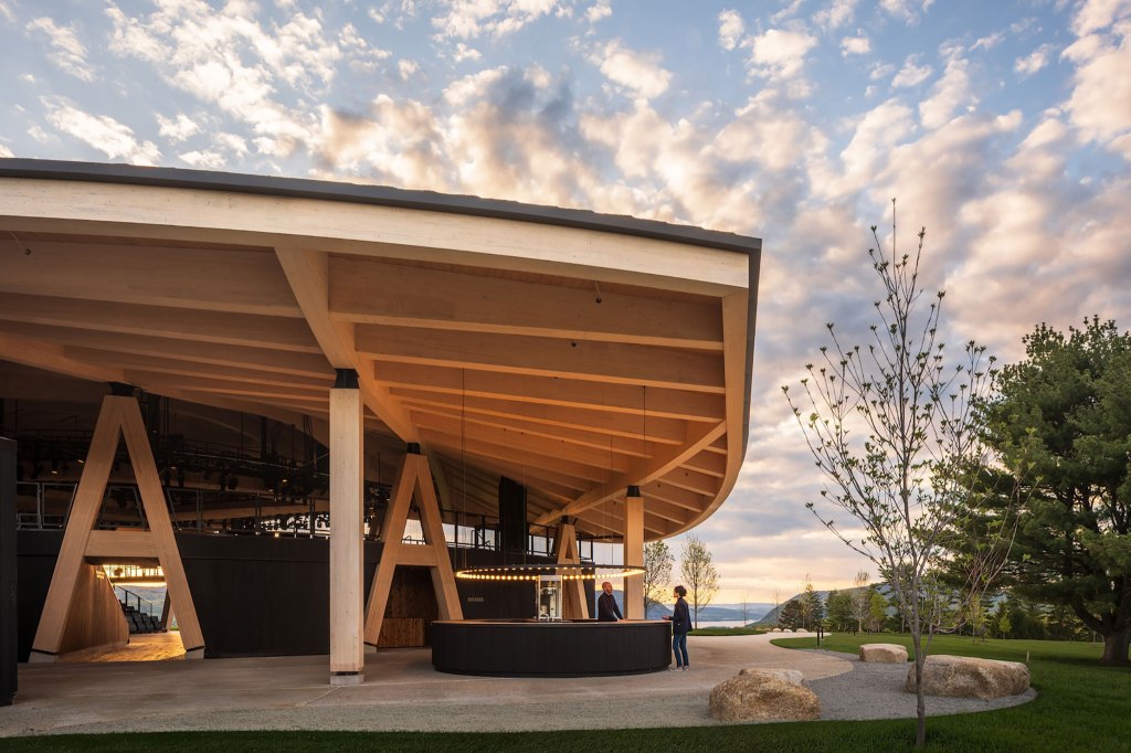 Curved timber roof and open-air entrance of the Samuel H. Scripps Theater Center in Garrison, New York